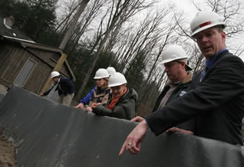 DEP engineer Sean McAndrew (right, pointing) shows Commissioner Emily Lloyd (center) some of the work that was done to wake the Ashokan Release Channel ready for use. In this area barricades were erected to direct the flow of water away from buildings that are part of the Ashokan Field Campus. Up to 600 million gallons of water per day will flow through the channel from the Ashokan Reservoir in order to decrease the chance of flooding in downstream communities along the lower Esopus Creek.