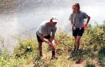 AmeriCorps members "flagging" stream bank level on the West Branch Delaware River in Hamden.