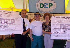 Commisioner Miele (center) hands out the first hiking permits to Annmarie K. Baisley, Supervisor, Town of Kent, and Robert J. Bondi, County Executive of Putnam County during the Putnam County Hospital Fair.