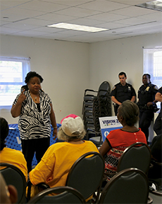 A woman speaks about traffic safety to a group of adult at a senior center.