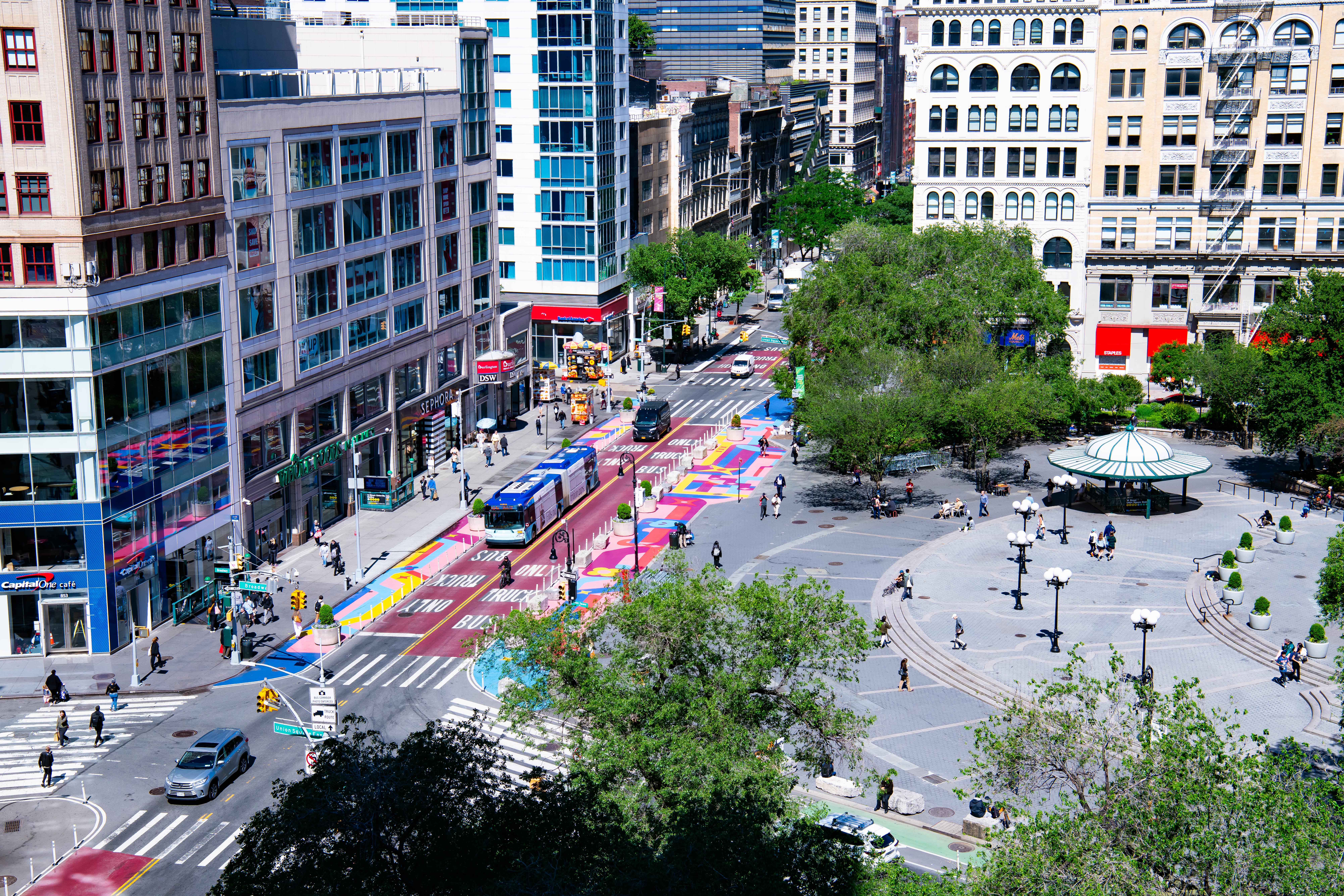 A couple walk along a wide sidewalk in Manhattan's Alphabet City.