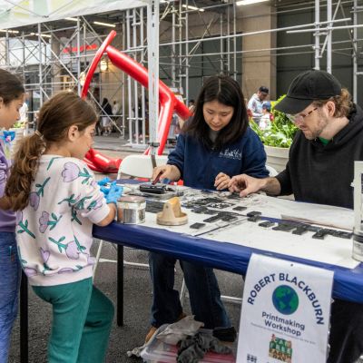 Two young children participate on a printmaking workshop at Car-Free Earth Day.