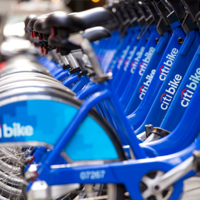 Close up of blue Citi Bikes parked in a row.