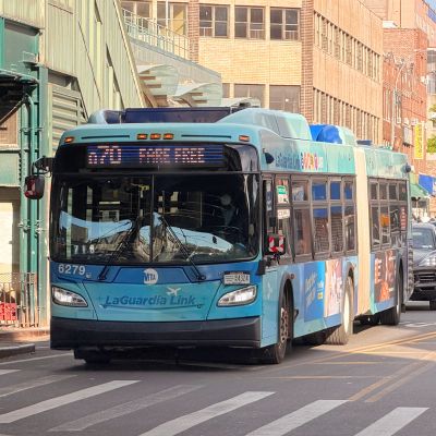 A Q70-SBS travels along Broadway in Jackson Heights, Queens.