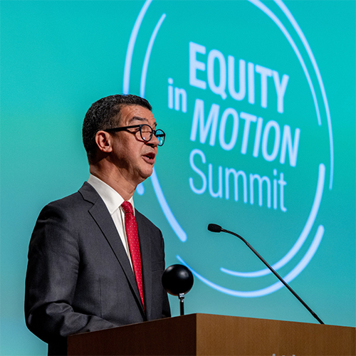 New York City Department of Transportation Commissioner Ydanis Rodriguez stands at a podium during the Equity in Motion transportation summit.