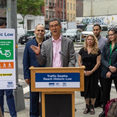 Commissioner Rodriguez makes an announcement from behind a podium.