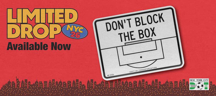 White and black rectangular sign reads Don't Block the Box and includes outlines of the penalty and goal boxes in front of a soccer goal. Limited drop by N Y C D O T.