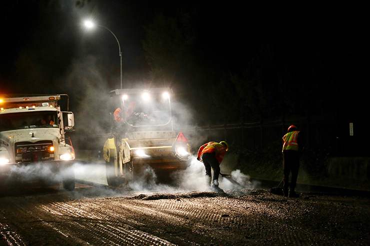 NYC D O T repave a roadway using rubber asphalt