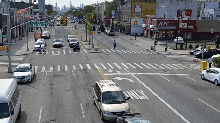 After Conditions: Pedestrians cross Northern Boulevard at 88th Street via a newly constructed pedestrian refuge island that encourages slower, safer turns and shortens crossing distances.