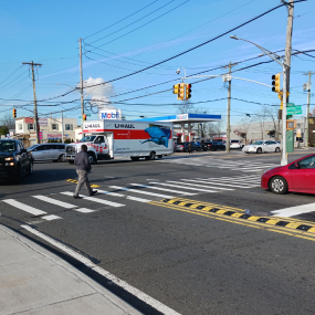 Yellow and black rubber speed bumps separate traffic lanes and slow left turns.