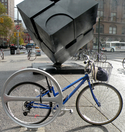 Mahaffy Degreeve bicycle rack in form of a large steel circle.