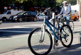 Bicycle chained to rack that was converted from a parking meter