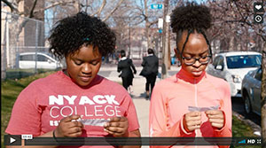 2 young girls looking at piece of paper in hands