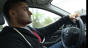 Man behind steering wheel in car