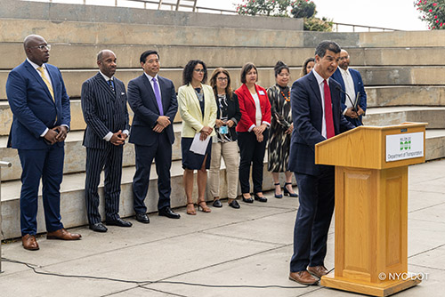 N Y C D OT Commissioner Ydanis Rodriguez addresses a crowd from behind a podium at the Doing Business with N Y C D O T Event on July 18, 2022.