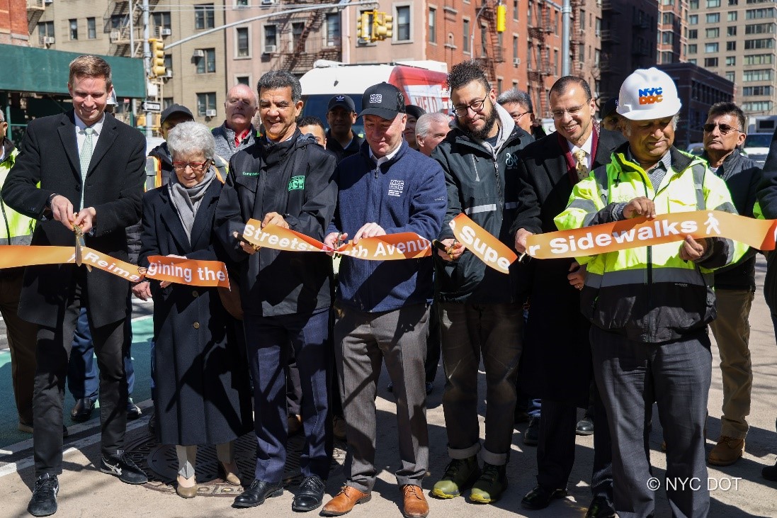 Council Member Erik Bottcher, DOT Commissioner Rodriguez, DDC Commissioner Thomas Foley, DEP Commissioner Rohit Aggarwala, and advocates cut a ribbon to celebrate the completion of water supply and pedestrian upgrades along Ninth Avenue in Manhattan.