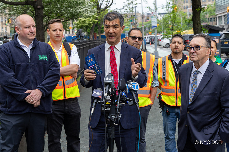 Commissioner Rodriguez and D O T staff speak at a press conference about pay-by-plate parking meters.