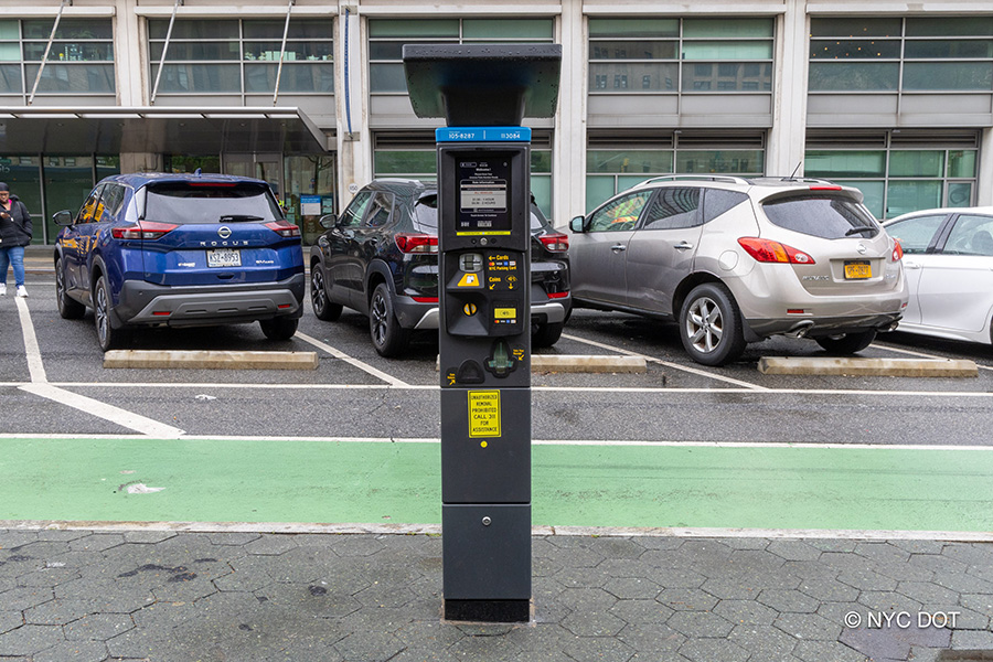 Pay-by-Plate parking meter pictured on the side of a street in northern Manhattan.
