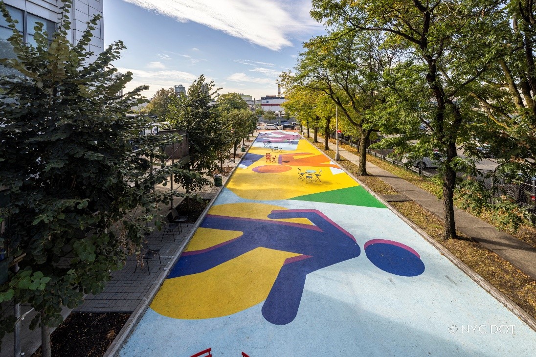 A photo of 29th Street Plaza features one of New York City’s largest asphalt murals currently on display. 