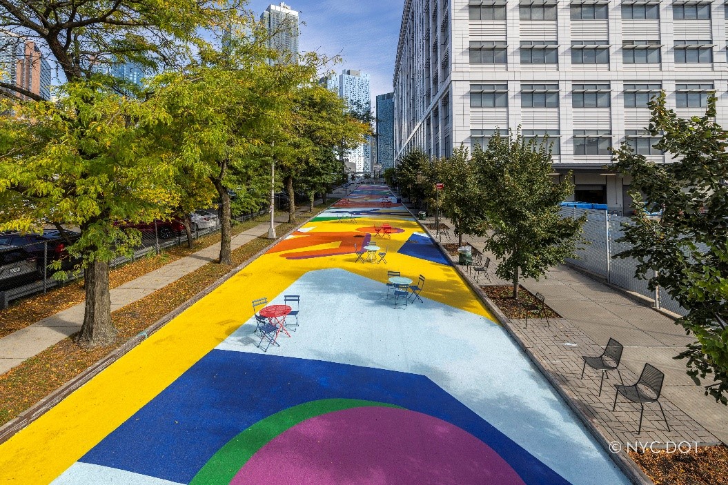 A photo of 29th Street Plaza features one of New York City’s largest asphalt murals currently on display. 