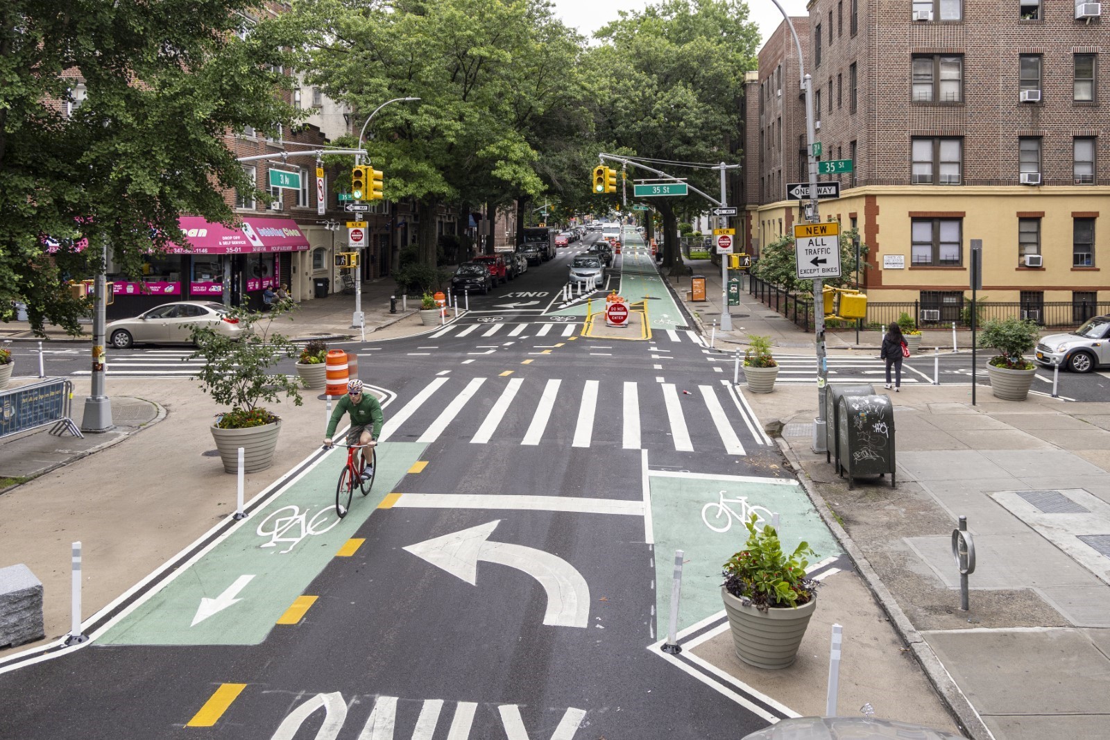 Newly installed planters and granite blocks improve visibility and painted curb extensions along 31st Avenue.