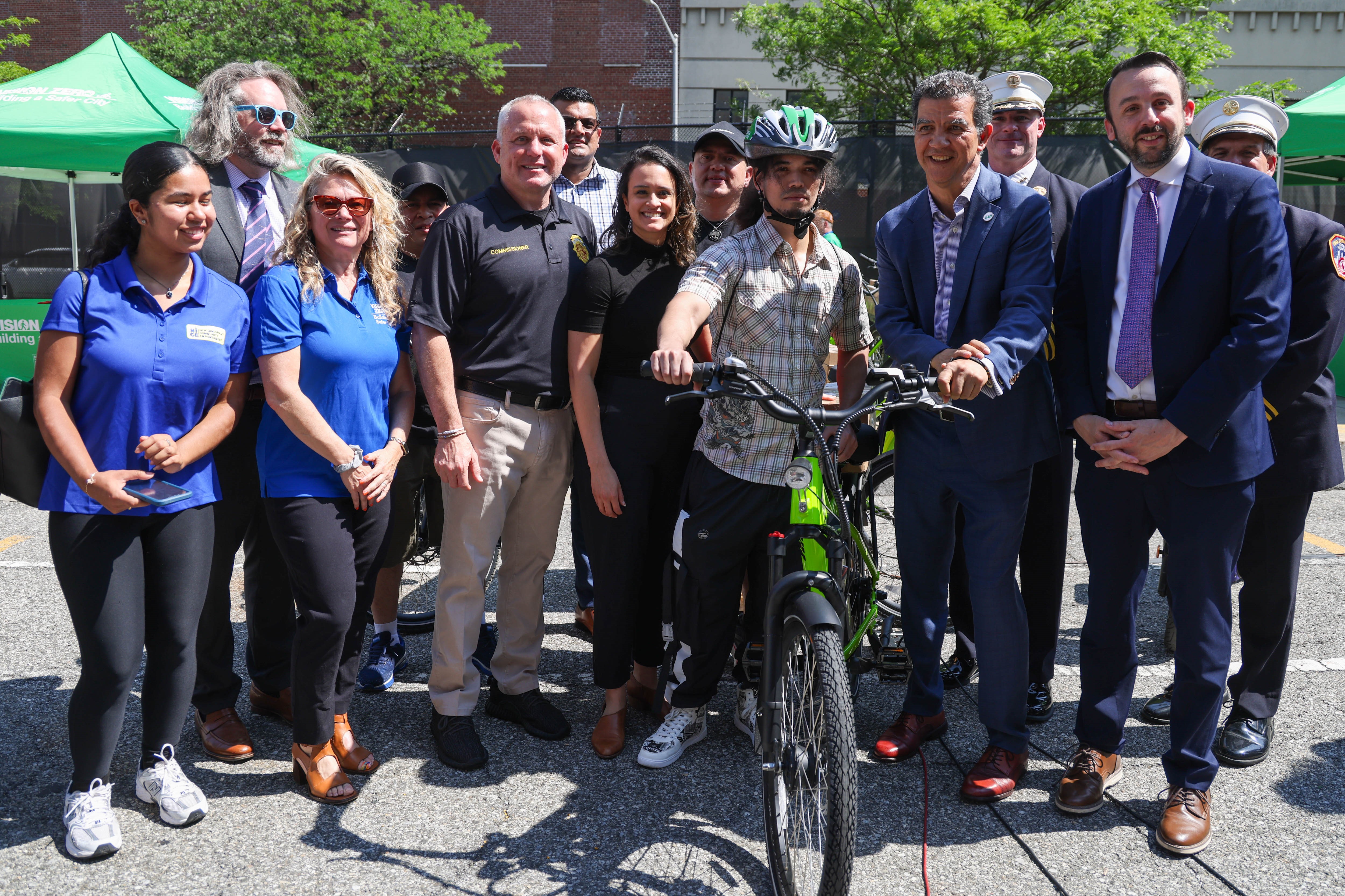 Commissioner Rodriguez, Commissioner Tucker, and others with a delivery worker receiving a fire-safe certified e-bike at the E-Bike Trade-In pilot program event. Credit: NYC DOT