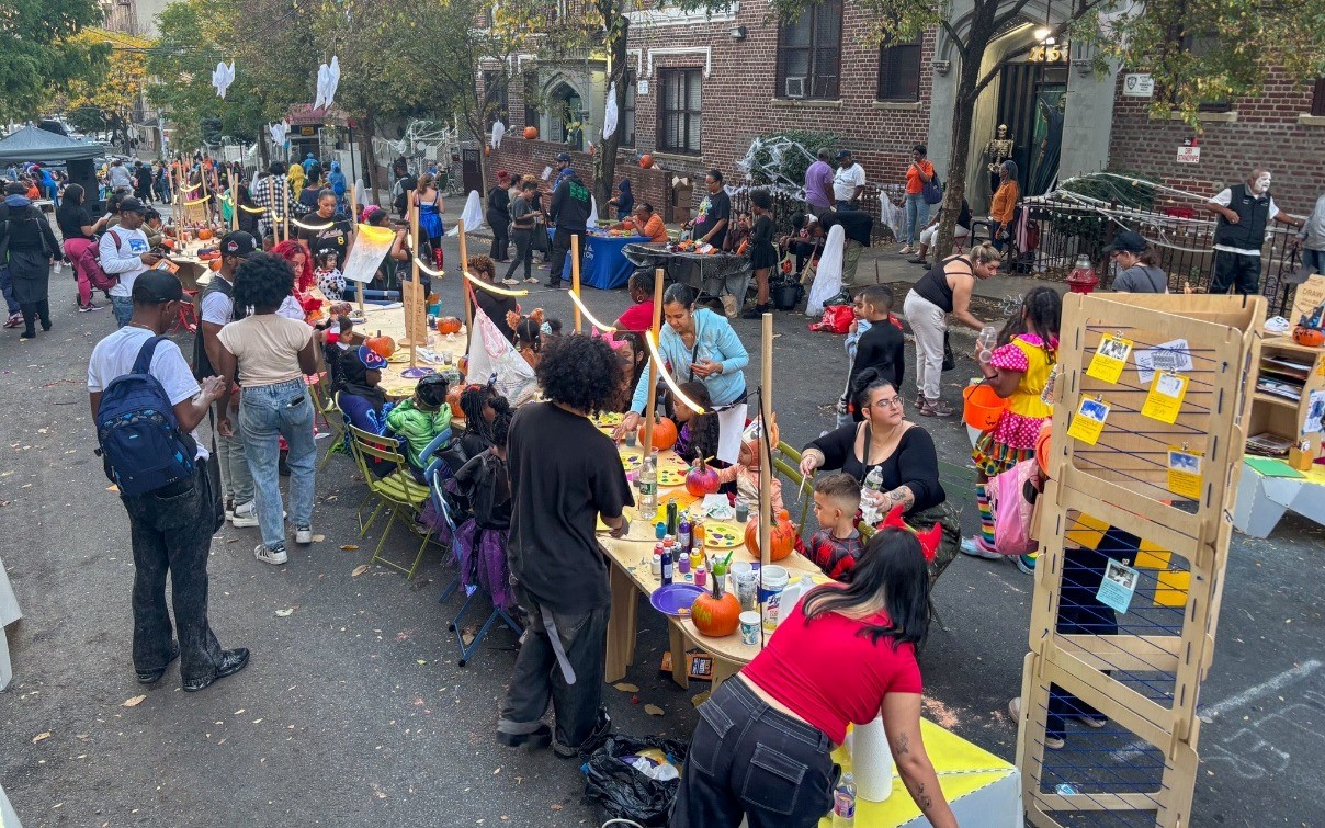 A photo of New Yorkers gather at a ’Trick-or-Streets’ event on Decatur Avenue in The Bronx