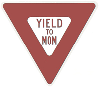 Yield to Mom sign. Triangle shaped. Red and white background with red lettering.