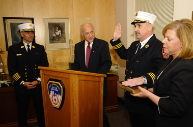 Chief Robert Byrnes is sworn in as chief fire marshal by Fire Commissioner Nicholas Scoppetta as Chief of Department Salvatore Cassano and Chief Byrnes wife, Maria, look on.