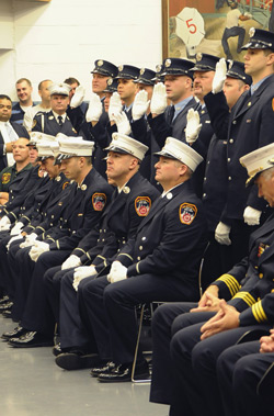 The newly promoted fire lieutenants take the oath of office.