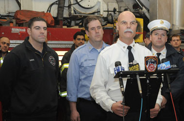 Battalion Chief Gerald Koziak from Battalion 8 informs the media about both fires in Manhattan along with (L to R) Firefighter Joseph Barone of Ladder 2, Capt. Kevin Harrison of Ladder 2 and Battalion Chief Jack Joyce of Battalion 9.