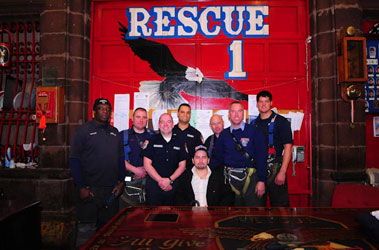 Rescue Paramedic Juan Henriquez (fourth from left), Lt. Tom Donnelly (second from right) and Firefighter Sean Cummins (third from right) are reunited with Jhon Gallego (seated), who was buried under 30 feet of debris after the crane collapse on March 15, 2008. They are joined by other members of Rescue 1 and Paramedic Henriquez's partner, Rescue Paramedic Marco Girao.