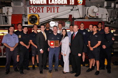 Firefighter Charles Maloney (center) after receiving the Firemark Award with members of Engine 15/Ladder 18 and Matt Morse, Liberty Mutual Sales Representative; Rose Singh, Liberty Mutual Midtown Branch Manager; and Gary Bennett, Liberty Mutual Area Manager for New York City.