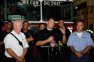 Firefighter Andy Bowman describes his water rescue in the East River with Battalion Chief Thomas Reilly (far left), Lt. Frank Giacoio (far right) and members from Ladder 7.