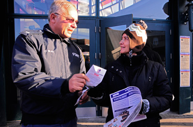 Retired Fire Lt. Bruce Silas hands out fire safety information at the 74th Street train station in Jackson Heights, Queens.