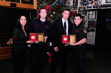 Firefighters Justin McNally (second from left) and Ronald Corsale (right) receive Firemark Awards from Liberty Mutual representatives Rose Singh and Jason Gerasia.