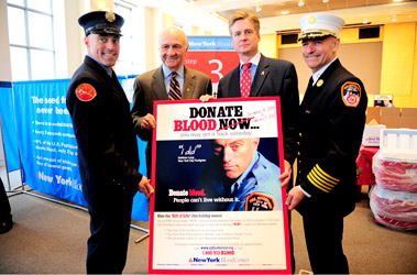 (L to R) Firefighter Matthew Long, Fire Commissioner Nicholas Scoppetta, President and CEO of the NYBC Dr. Christopher Hillyer and Chief of Department Salvatore Cassano with the poster announcing the Critical Days Program featuring Firefighter Long.
