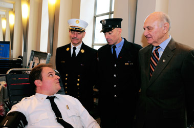 Chief of Department Salvatore Cassano, Firefighter Matthew Long and Fire Commissioner Nicholas Scoppetta speak with Lt. Mike Durkin, who donated blood during a drive at FDNY Headquarters on Dec. 14.