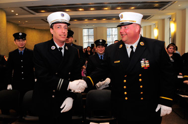 Deputy Chief Bruce Medjuck (left) and Division Chief Albert Gehres congratulate one another on their promotions.