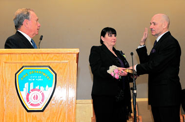 Fire Commissioner Salvatore Cassano (standing with his wife, Theresa) takes the Oath of Office, administered by Mayor Michael Bloomberg.