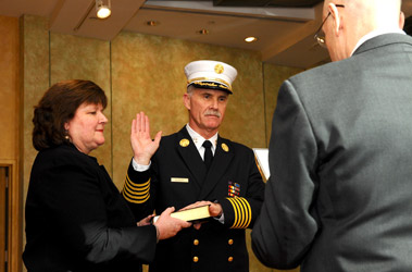 Fire Commissioner Salvatore Cassano officially swears in Edward Kilduff as the FDNY's 34th Chief of Department with his wife, Kathy, at his side.