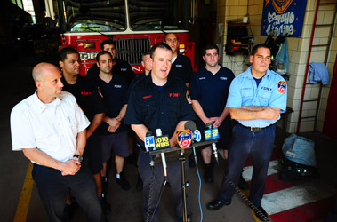 Firefighter Sean Connolly describes the rescue with Chief Joseph Omeste (left) and Lt. Edward Gonzalez (right).