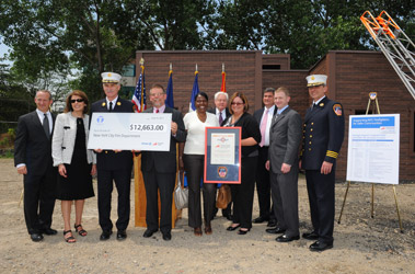 Chief of Department Edward Kilduff, First Deputy Commissioner Don Shacknai and Chief of the FDNY Academy James Mooney accept the grant from representatives from Taylor & Taylor Associates and Fireman's Fund Insurance.