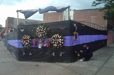 The site of the fire in Queens, lined with bunting and tributes to mark the 10th anniversary of the tragic Father's Day fire.