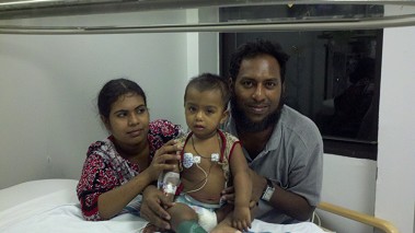 The baby boy the EMS members saved and his parents.
