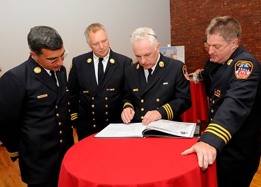 Chiefs Marrone, Raynis, Baggott and Dalton peruse the commemorative book