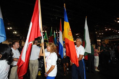 Flags from all 75 countries represented at the Games are carried into the closing ceremony.