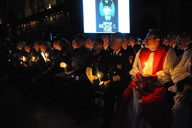 Chief of Department Edward Kilduff (center with five stripes on his sleeves) watches the list of first responders lost on 9/11.