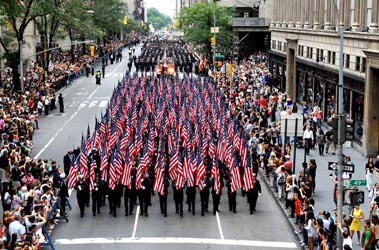 The 343 flags march down Fifth Avenue following the service.