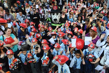 Children from schools in all five boroughs take the oath as Junior Firefighters and EMTs during the Fire Prevention Week kick off at Rockefeller Center.